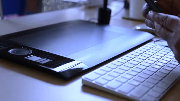 Designer working with graphics tablet, hands of a man working with drawing tablet for a computer, Blue toned ,Soft focus shot(HD, high definition 1080p) — Stock Video