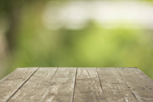 Empty wood table top on forest background. can montage or displa