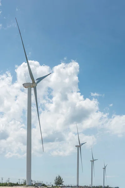 White wind turbine generating electricity on seacoast — Stock Photo, Image