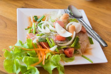 Beyaz arka plan üzerinde baharatlı salata ile erişte