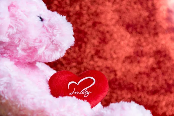 Ursinho de pelúcia com coração no fundo vermelho, conceito valentine — Fotografia de Stock