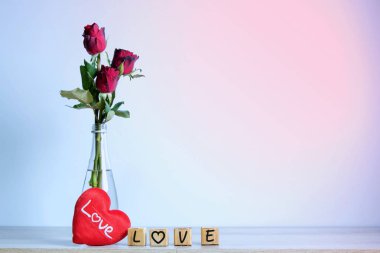  Kalp ve ahşap alfabe ile kırmızı gül