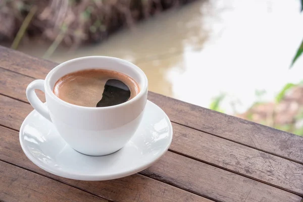 Кофейная чашка на деревянном столе — стоковое фото