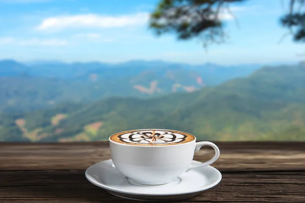 Coffee cup with steam on a wooden table