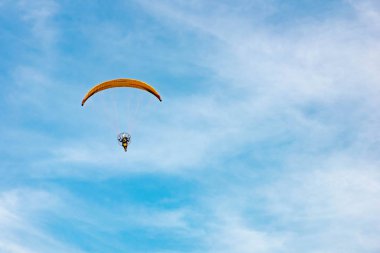 Paramotor 'a binen adam gökyüzünde uçuyor.