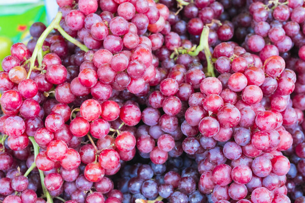 Fresh Red wine grapes or dark grapes at the fruit market