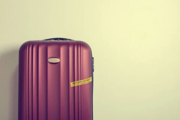 Four wheeled hard shell red suitcase — Stock Photo, Image