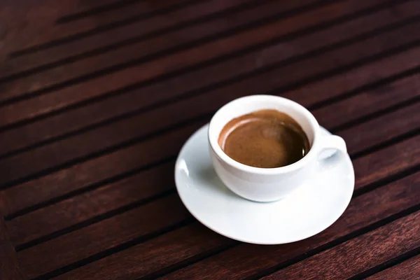 Cup of coffee on the wooden table — Stock Photo, Image