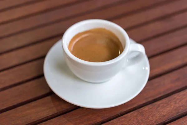 Cup of coffee on the wooden table — Stock Photo, Image
