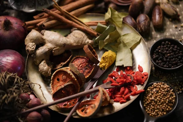 Spices and herbs on old kitchen table.