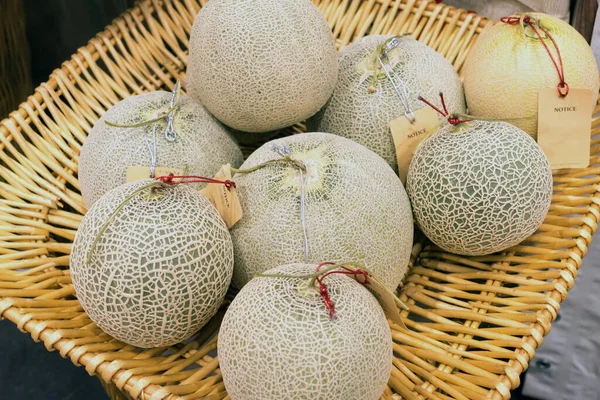 Fresh ripe melons or Cantaloupe melons sell in the market with blurred background. Cantaloupe melons background.