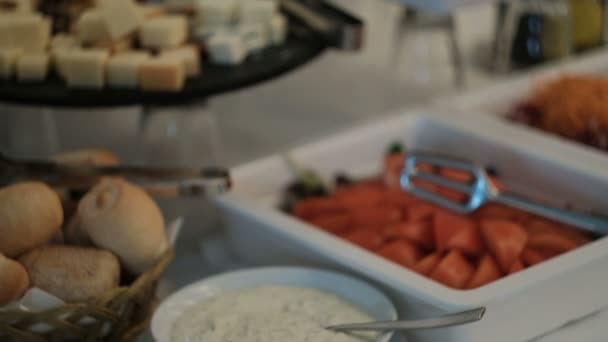 Sur la table du buffet, il y a différentes collations et plats de légumes .