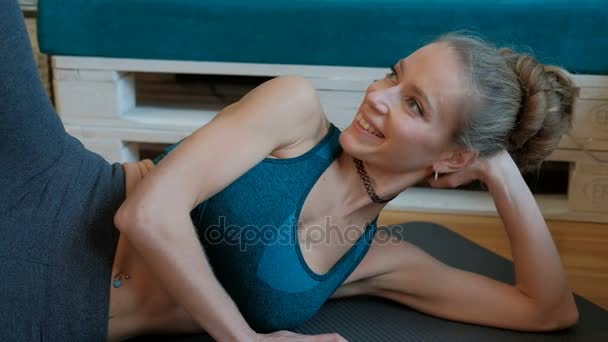 Smiling woman work-out lying on floor indoors. — Stock Video