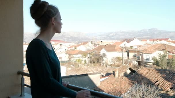 Młoda kobieta podziwia krajobraz na balkonie w swoim domu. — Wideo stockowe