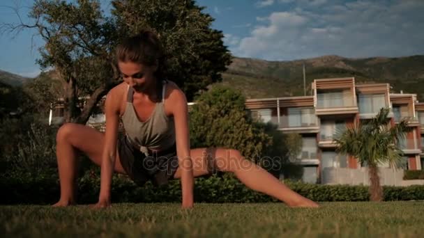 Beautiful woman sitting on a twine on the grass outdoors. — Stock Footage Beautiful woman sitting on a twine on the grass outdoors. Stock Video