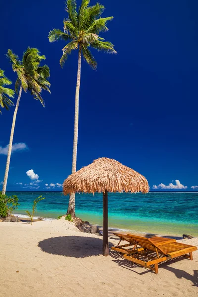 Beach chairs under umbrella — Stock Photo, Image