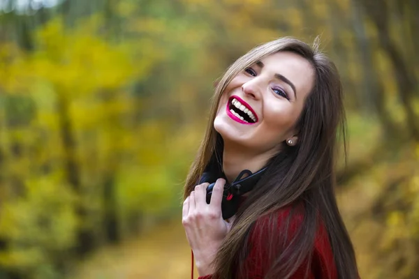 屋外秋のヘッドフォンで若い白人ブルネットの女性 — ストック写真