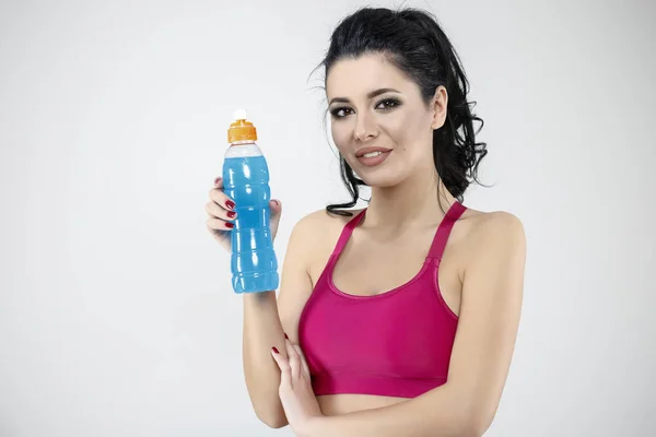 Attractive woman drinking water from bottle after exercise — Stock Photo, Image