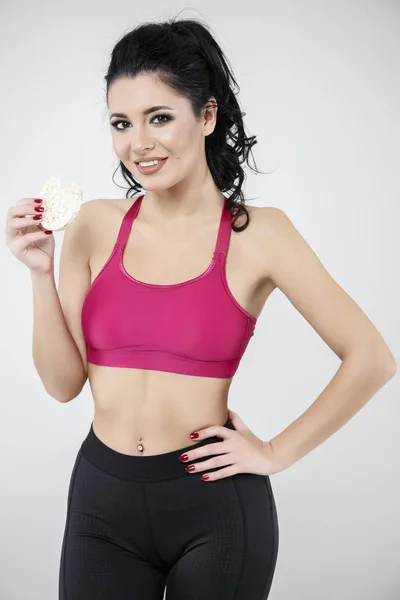 Diet sporty young woman eating cereal bar — Stock Photo, Image