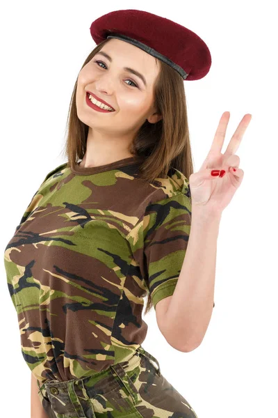 Jeune femme soldat en tenue de camouflage militaire montrant la paix — Photo