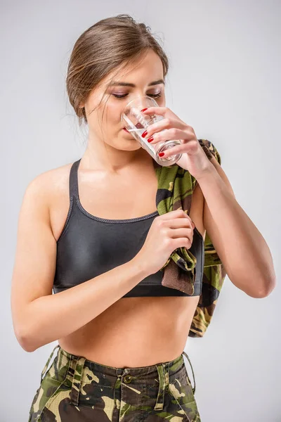 Soldier woman drinking water after exercise