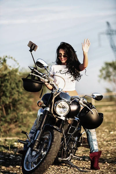 Beautiful motorcycle brunette woman with a classic motorcycle (c — Stock Photo, Image