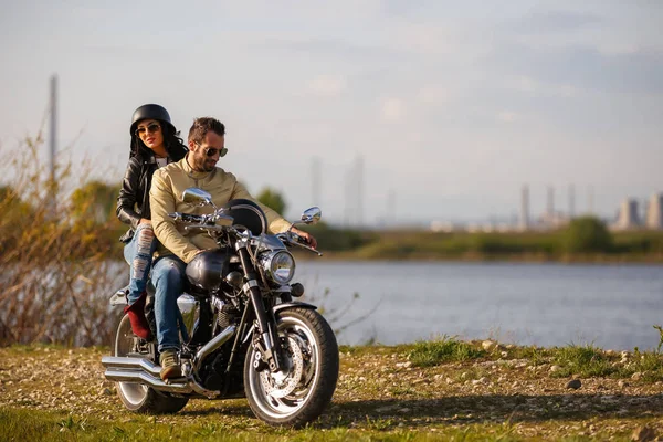 Belo jovem casal com uma motocicleta clássica — Fotografia de Stock