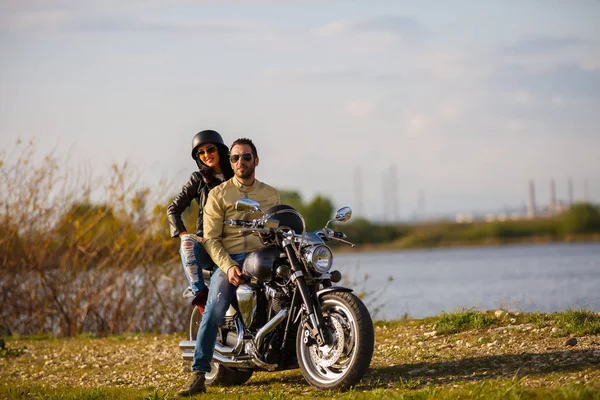 Belo jovem casal com uma motocicleta clássica — Fotografia de Stock