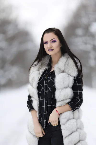 Winter portrait with a woman with colored eyes — Stock Photo, Image