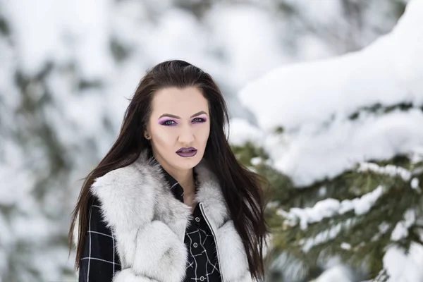 Winter portrait with a woman with colored eyes — Stock Photo, Image