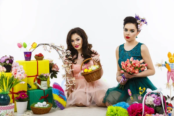 Two beautiful girlfriend girls, basket with eggs and flower deco — Stock Photo, Image