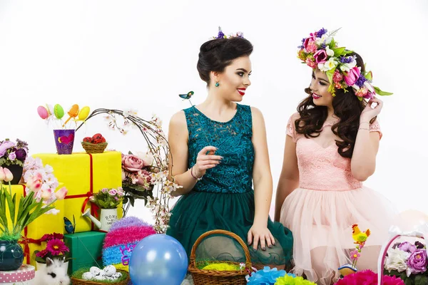 Two beautiful girlfriend girls, basket with eggs and flower deco — Stock Photo, Image