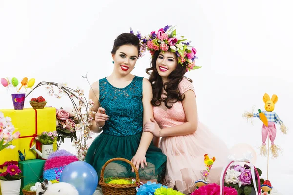 Two beautiful girlfriend girls, basket with eggs and flower deco — Stock Photo, Image