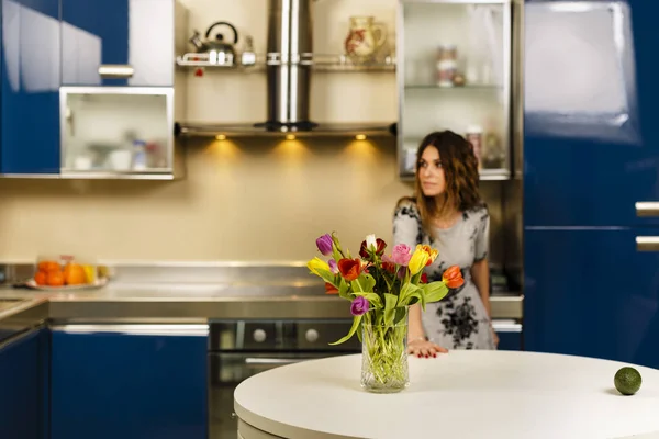 A bouquet of tulips with a lady in blurred background — Stock Photo, Image