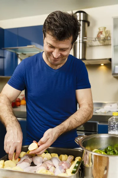 Cuisiner à la maison - l'homme prépare un plateau de pilons de poulet et — Photo