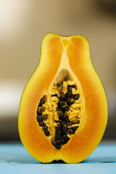 Closeup of a papaya fruit over blurred background — Stock Photo, Image