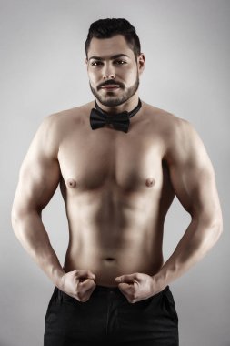 Handsome muscular man posing in studio clipart