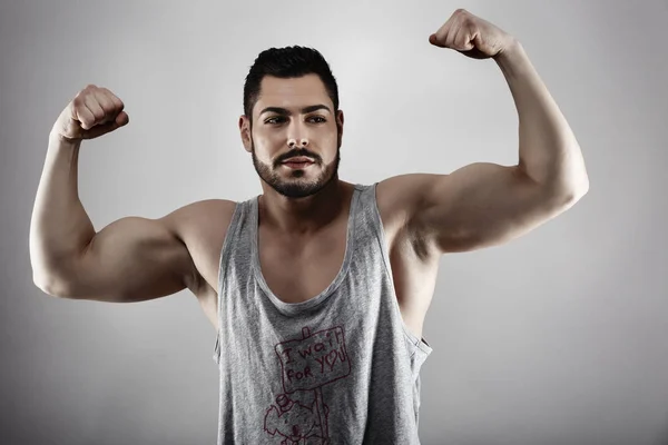 Handsome muscular man posing in studio — Stock Photo, Image