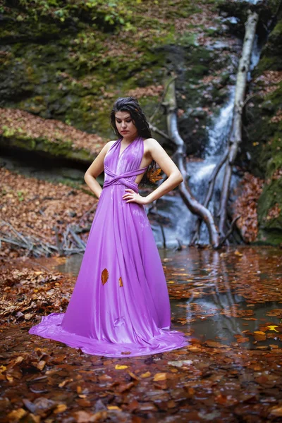 Portrait of a beautiful hispanic young woman near waterfall in a — Stock Photo, Image