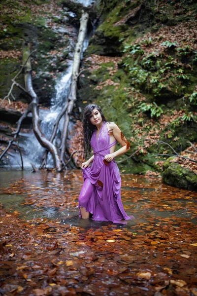 Porträt einer schönen hispanischen jungen Frau in der Nähe eines Wasserfalls in einem — Stockfoto