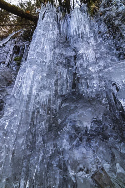 Ghiaccioli splendidamente sagomati su una montagna da una cascata ghiacciata — Foto Stock