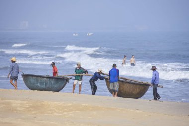 Da Nang, Vietnam - 16 January 2020: The traditional basket fishing boat docked at the beach.