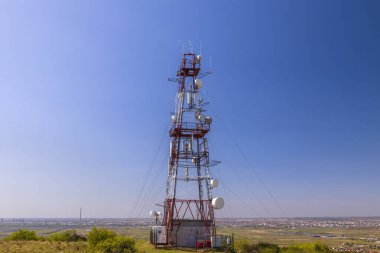Tepede antenleri olan telekomünikasyon kulesi.