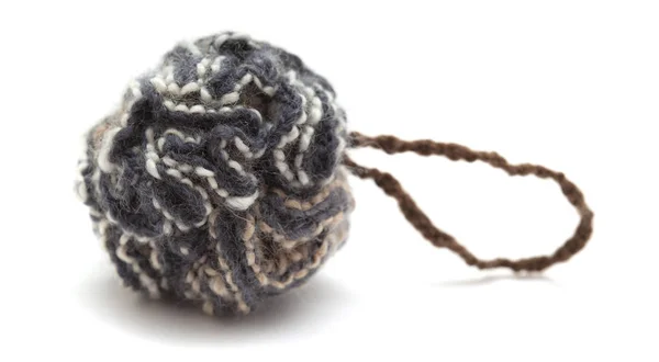 Knitted pompom of variegated yarn — Stock Photo, Image