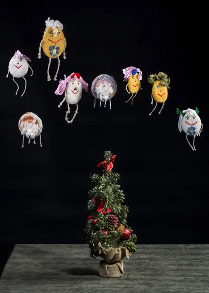 Toys made of felted wool on the Christmas tree on the black background — Stock Photo, Image