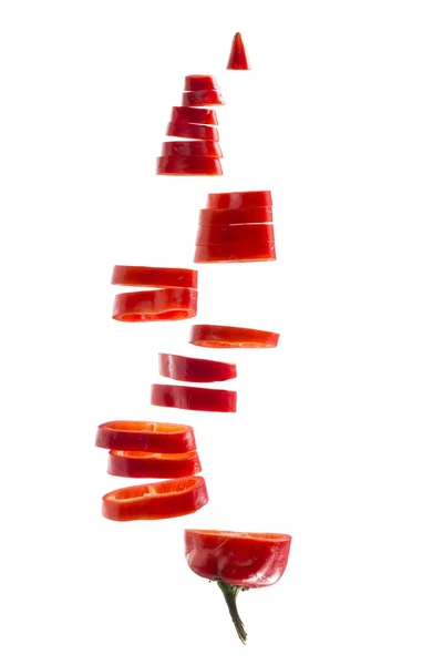 Нарезанный красный перец на белом фоне — стоковое фото