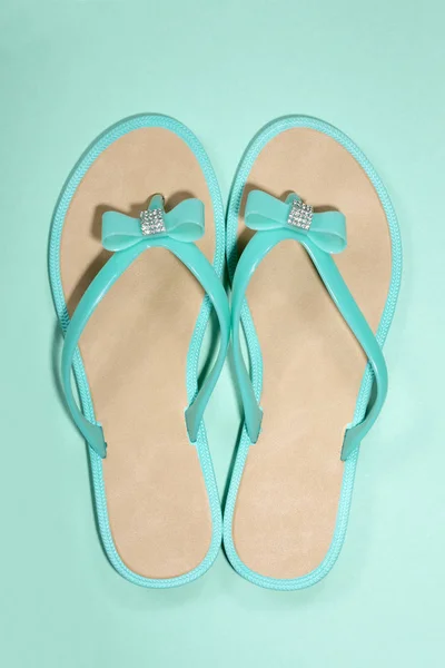 Women's summer sandals on a green background