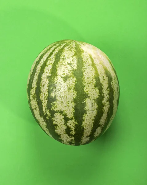 Ripe large watermelon on a green background. — Stock Photo, Image