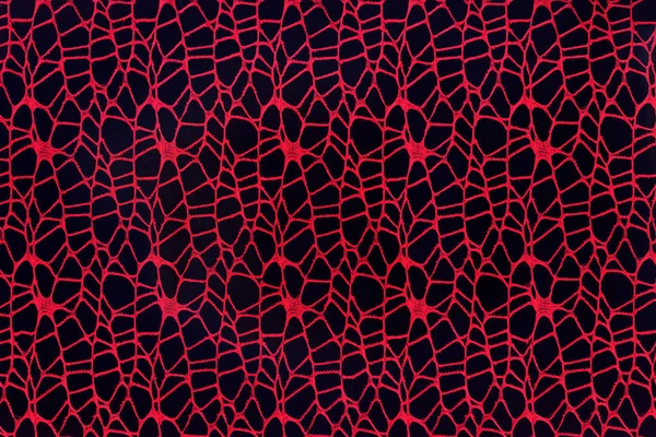 黒の背景に編まれた赤い糸の抽象的な背景. — ストック写真