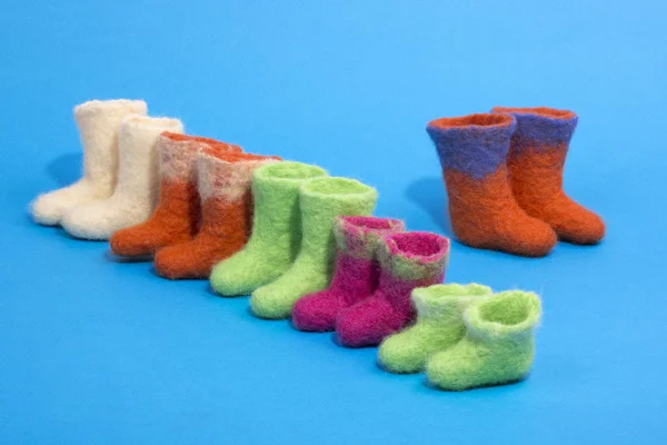 Souvenir boots made of felted wool on a blue background — Stock Photo, Image